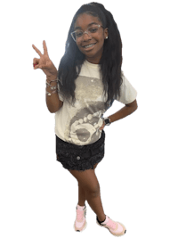 a young girl posing for a picture with a peace sign